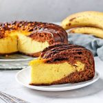 Homemade Chocolate Cake with cottage cheese and banana filling, with piece of cake cut off in the foreground