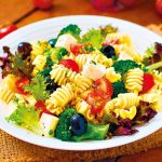 Pasta salad with tomato, broccoli, black olives,  and cheese feta