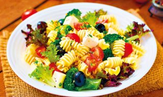 Pasta salad with tomato, broccoli, black olives,  and cheese feta