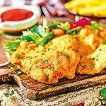 Tender schnitzel with fresh salad, tomatoes and french fries