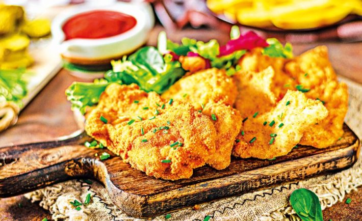 Tender schnitzel with fresh salad, tomatoes and french fries